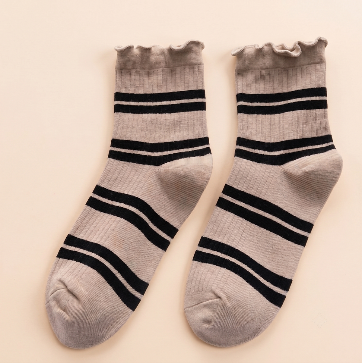 Ankle boot socks in oatmeal with black stripes, featuring a frilled cuff. Displayed flat as a pair on a neutral surface.