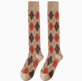 Argyle knee high socks in tan with rust and brown diamonds, featuring a preppy argyle pattern. Shown as an upright flat-lay pair.