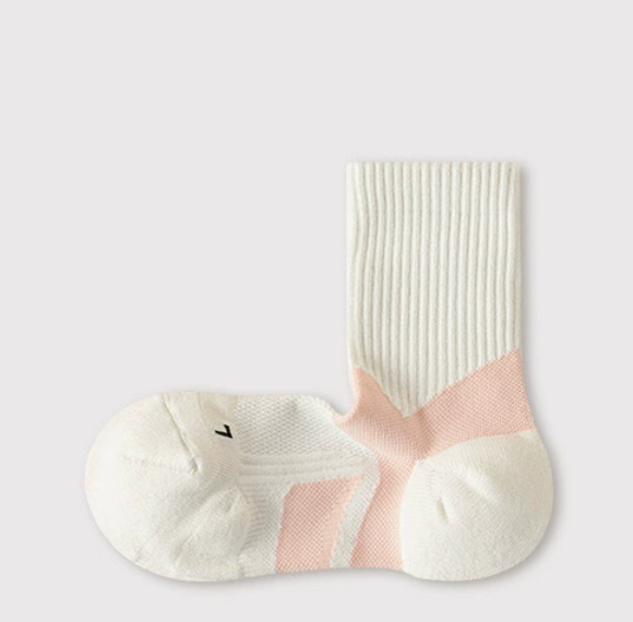 Athletic crew socks in cream and pink, featuring an arch support band. Displayed flat as a pair on a light surface.