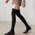 Black over the knee socks in black ribbed knit, featuring a thigh-high leg. Worn with black flats.