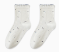 Breathable socks for sleeping in ivory cotton, featuring a scattered dot pattern and frilled cuff. Shown flat as a pair on a neutral surface.
