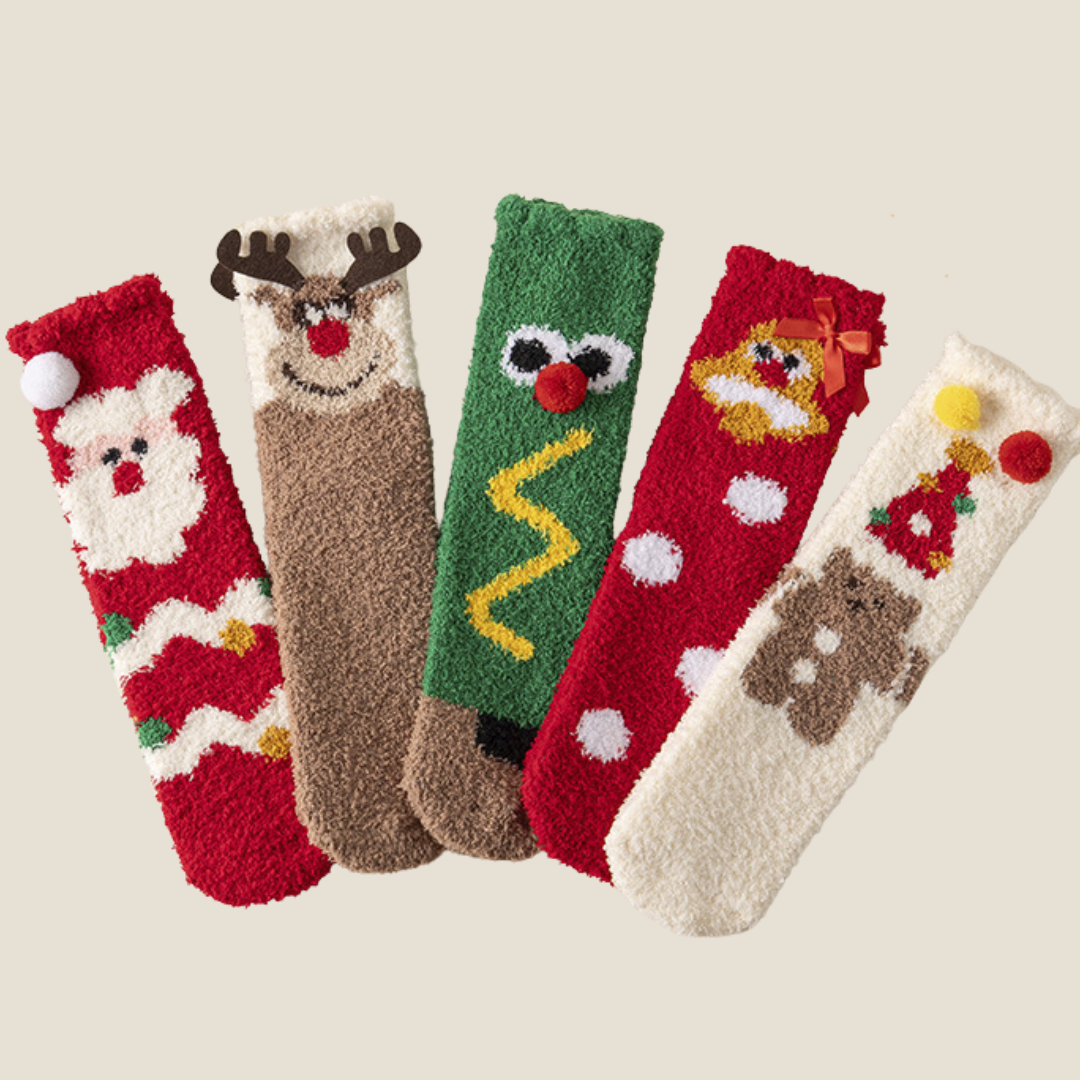Bulk Christmas socks, five assorted plush character pairs lined up in a flat-lay showing the variety in the pack.