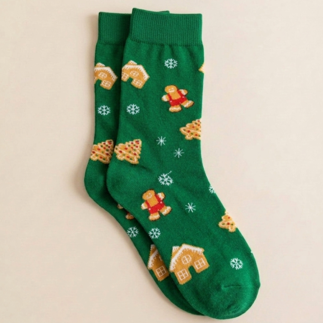 Gingerbread Christmas socks in green with cartoon gingerbread men and trees, flat-lay pair.