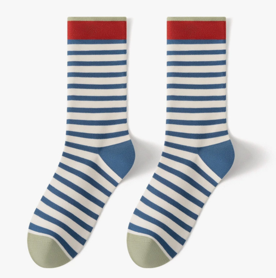 Comfortable crew socks in blue and white stripes with a red cuff, featuring a tan toe. Shown as a flat-lay pair.