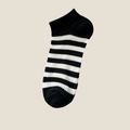 Comfy ankle socks in black and white stripes, featuring a cozy ribbed cuff. Shown as a single flat-lay on a light backdrop.