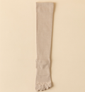 Compression toe socks in ivory ribbed knit, featuring a tall knee-high leg. Shown as a single flat-lay on a light surface.