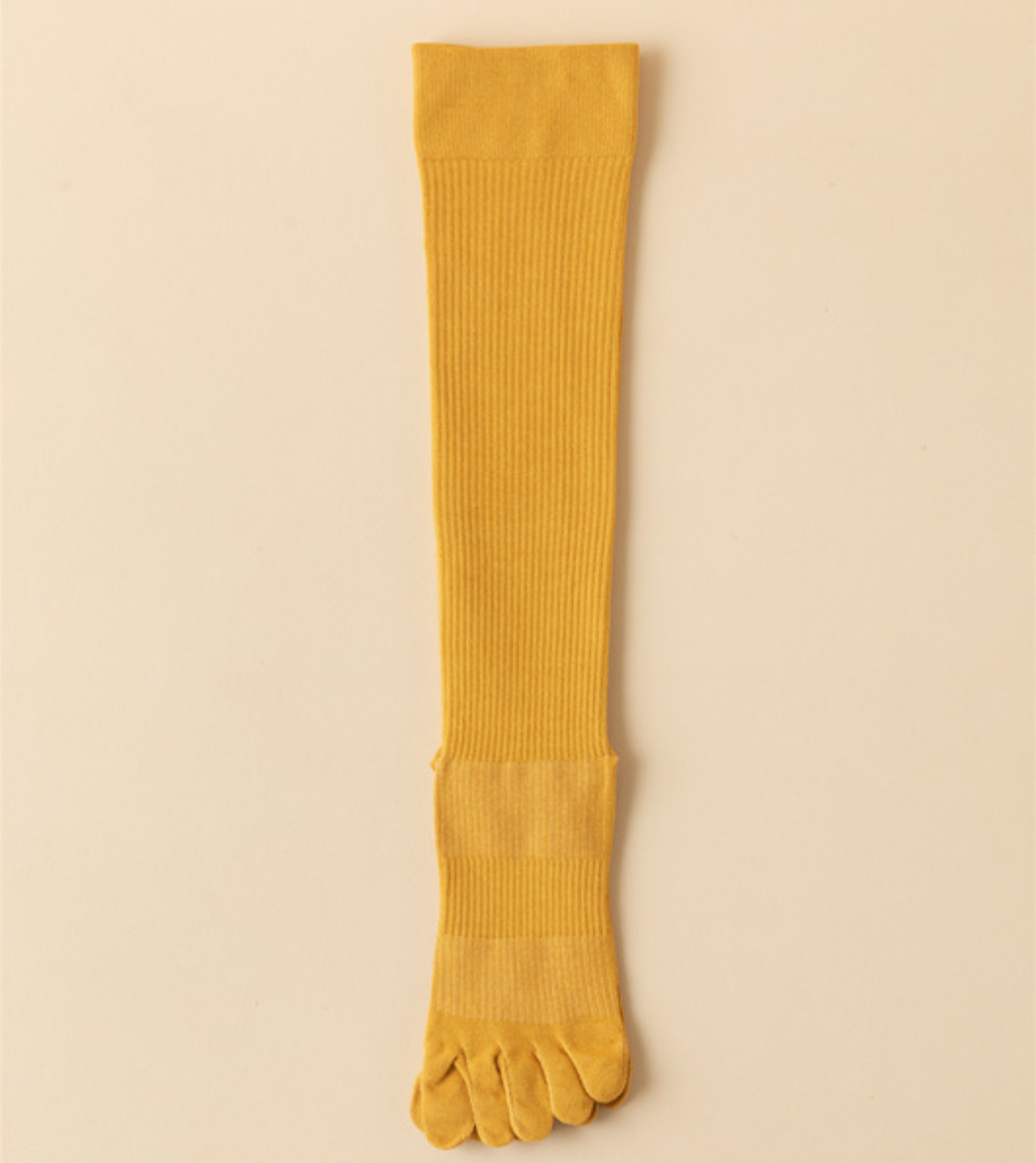 Compression toe socks in mustard yellow ribbed knit, featuring a five-toe design. Displayed flat on a neutral backdrop.