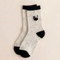 Cotton cat socks in the Bowknot style, cream speckled knit with an embroidered black cat and red bow, flat-lay pair.