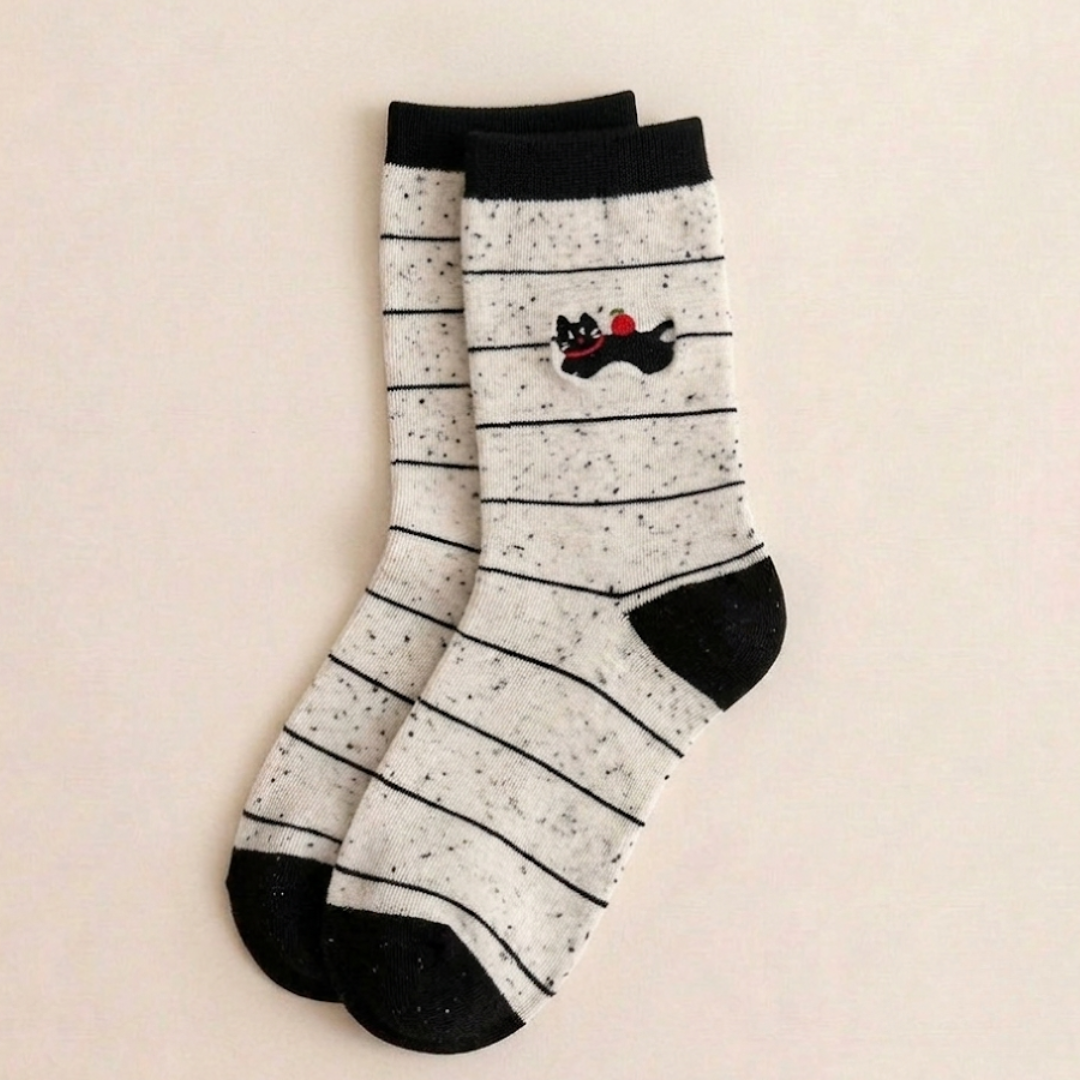 Cotton cat socks in the Striped style with a black cat and red bow, flat-lay pair.