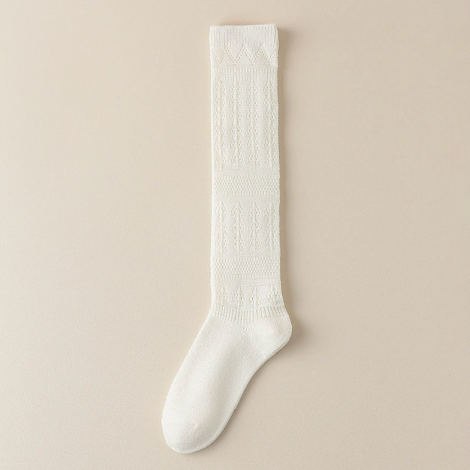 Cotton knee socks for women in ivory cable knit, featuring a ribbed cuff. Shown as a single flat-lay on a neutral backdrop.