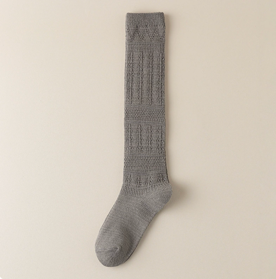 Cotton knee socks for women in soft grey ribbed cotton, featuring a snug knee-high leg. Displayed flat on a light surface.