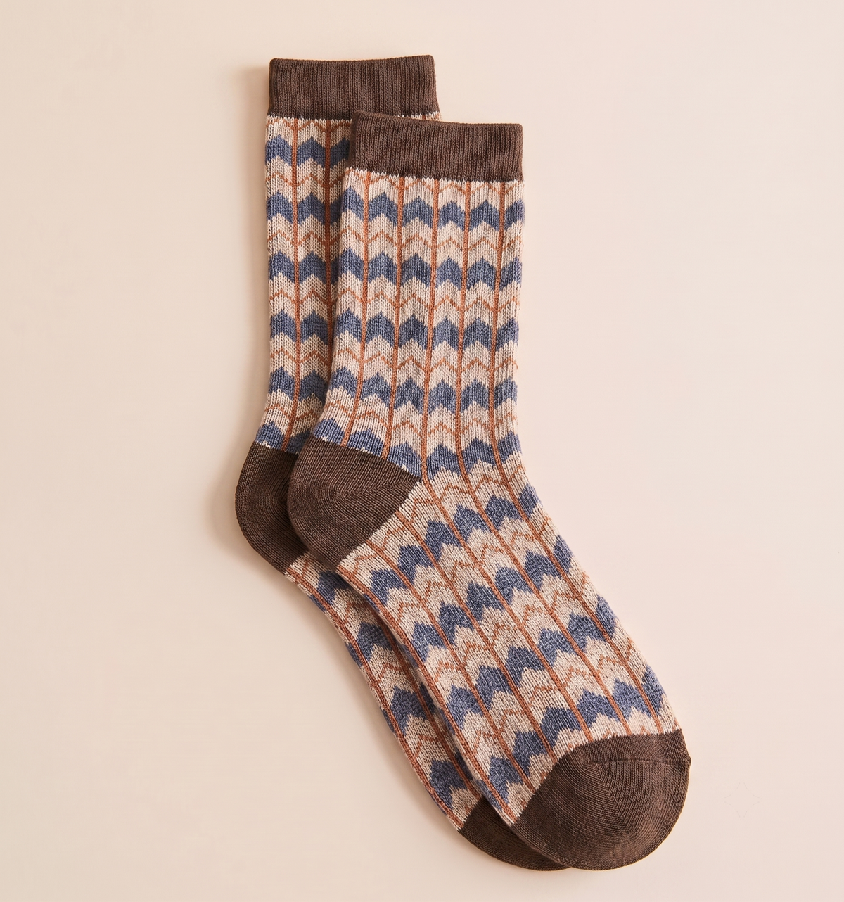 Cowgirl boot socks in tan and cream, featuring a striped Fair Isle knit with brown cuff and heel. Displayed flat as a pair on a neutral surface.
