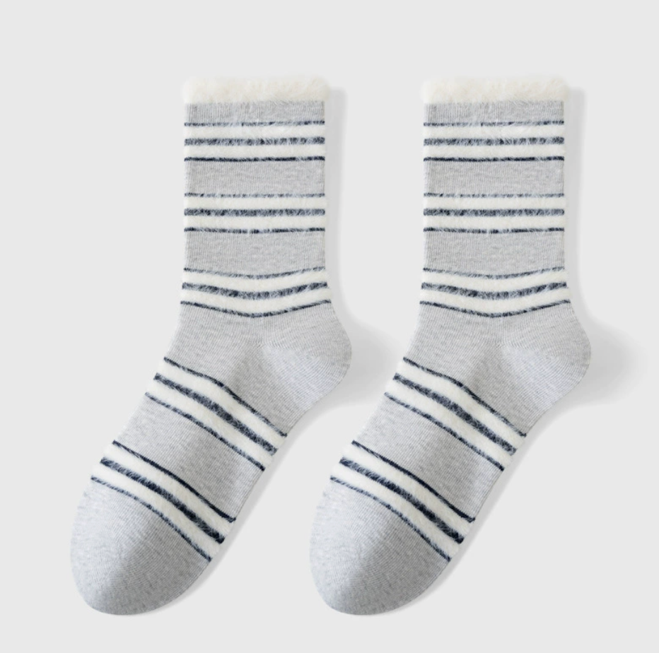 Cozy crew socks in white and grey with dark stripes, featuring a soft knit. Shown as a flat-lay pair on a neutral backdrop.