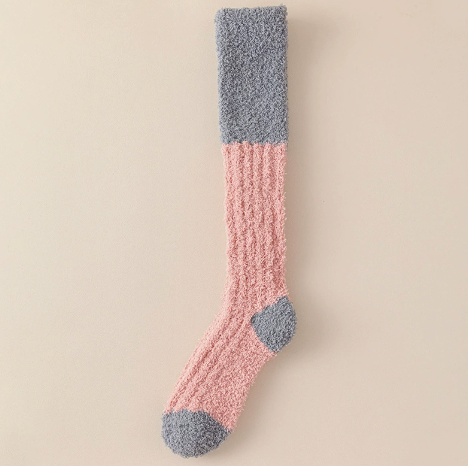 Cozy knee high socks in blush pink fleece, featuring grey colorblock detailing. Shown flat to display the full knee-high length.