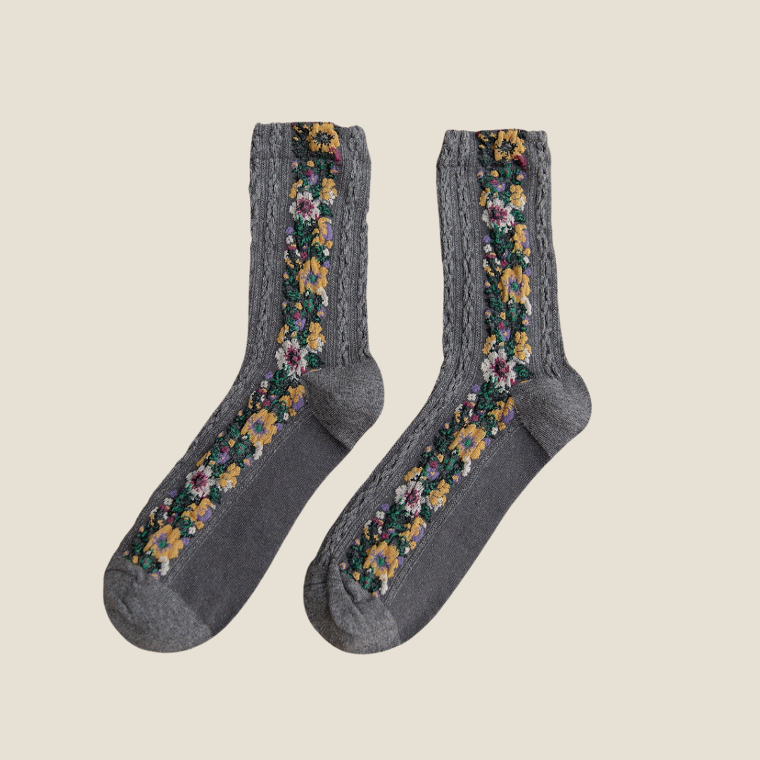 Cute floral socks in gray with embroidered floral panels, flat-lay pair.