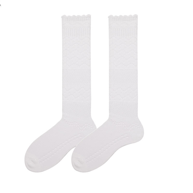 Cute knee high stockings in white pointelle knit, flat-lay pair showing the openwork pattern.