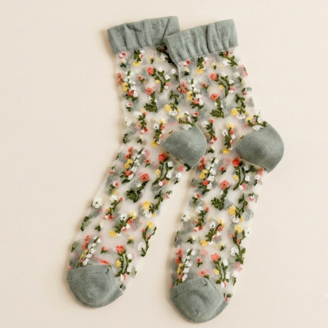 Cute sheer socks in floral embroidered mesh with a green cuff, flat-lay pair.