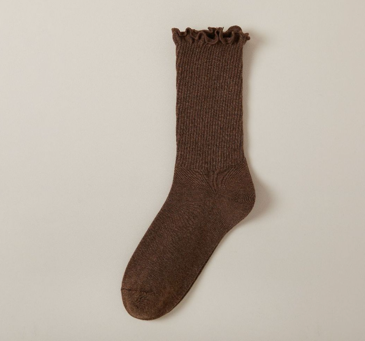 Cute socks for loafers in brown with a ruffle trim, a single sock shown against a neutral background.