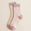 Cute winter socks for women in pink speckled ribbed knit with a contrasting heel and toe, flat-lay pair.