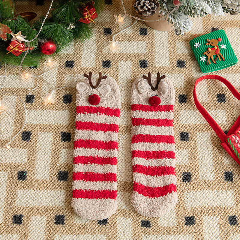 Cutest Christmas socks in red and white stripes with reindeer faces, flat-lay pair on a patterned rug.