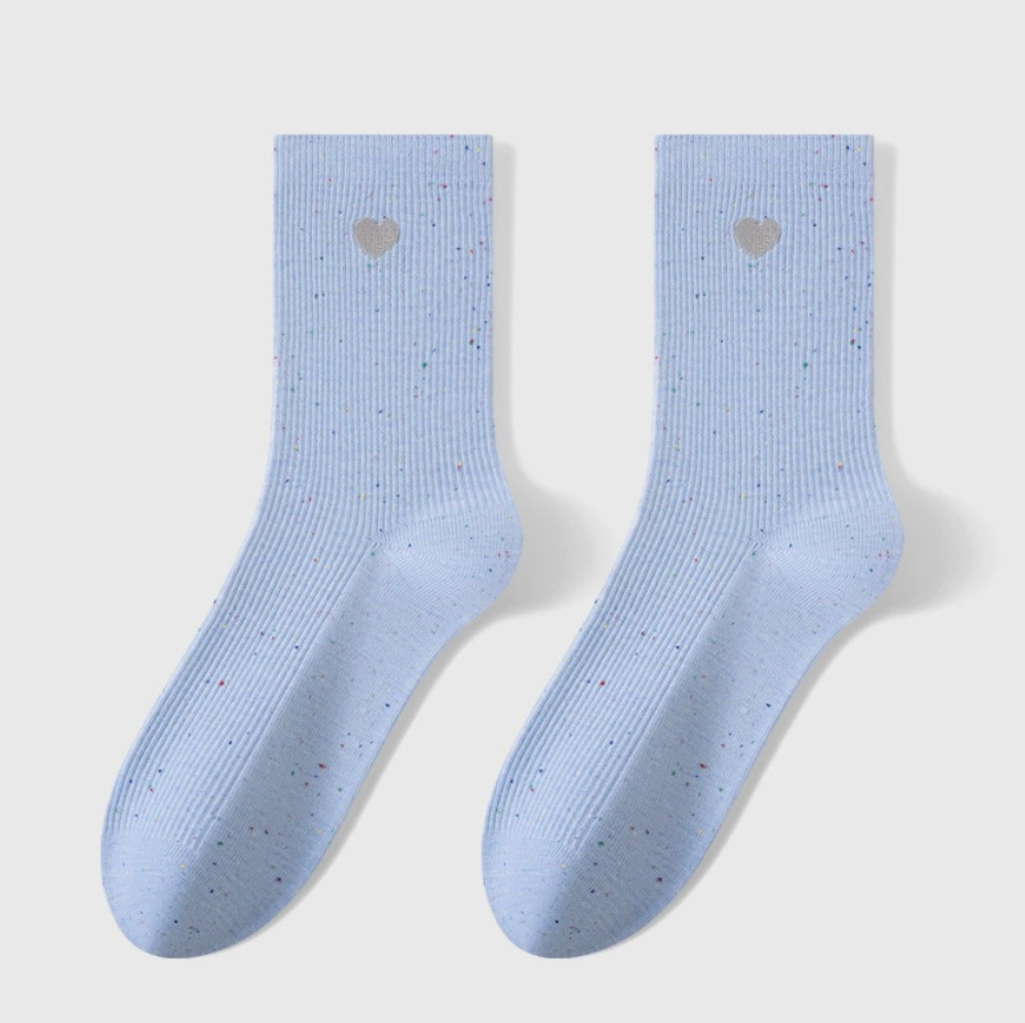 Embroidered crew socks in light blue knit, featuring a small heart motif. Shown as a flat-lay pair on a light backdrop.