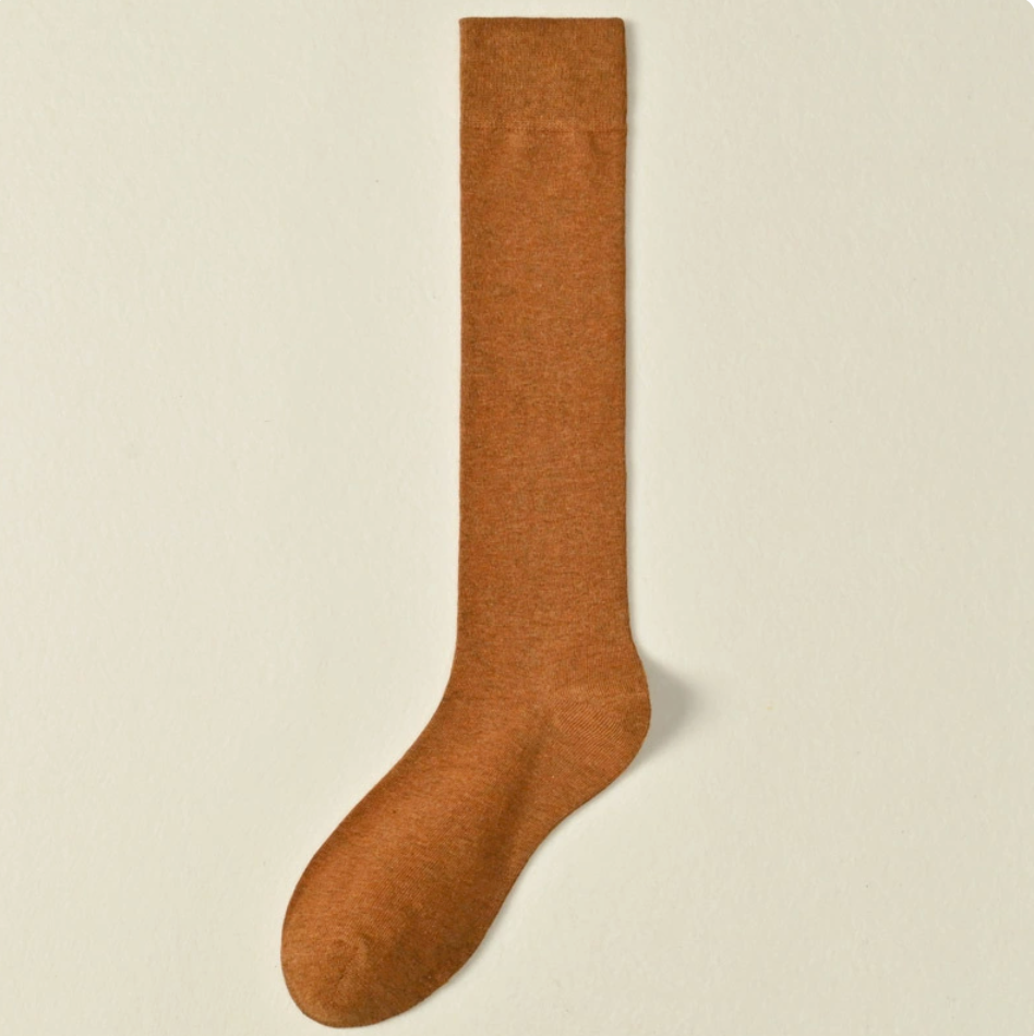 Female knee socks in caramel ribbed cotton, featuring a ribbed cuff. Shown as a single flat-lay on a light surface.