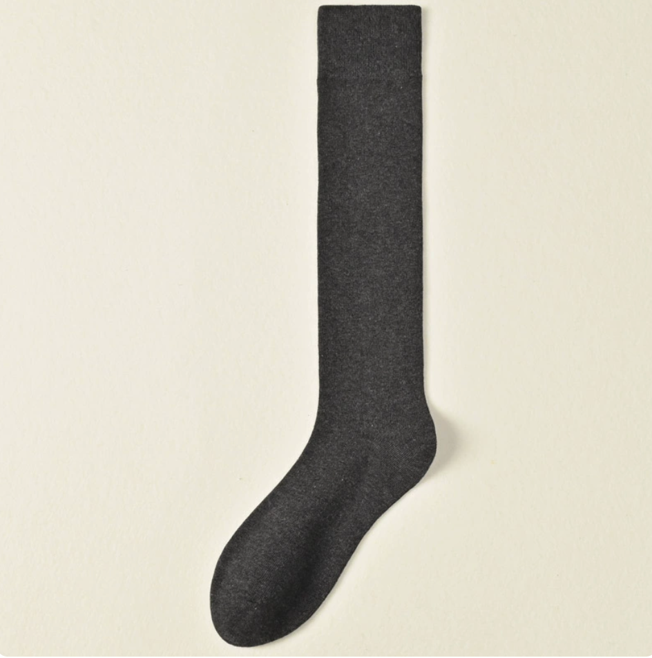 Female knee socks in dark charcoal ribbed cotton, featuring a soft knee-high leg. Displayed flat on a neutral backdrop.