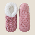 Fleece lined slipper socks in mauve cable knit, featuring a sherpa cuff and non-slip sole. Shown as a flat-lay pair on a neutral backdrop.