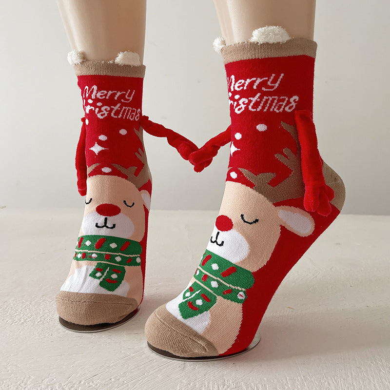 Funny Christmas socks in red with a reindeer Merry Christmas print and magnetic holding-hands feature.