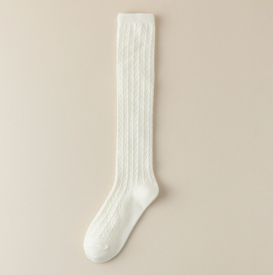 Gray knee socks for women in cream cable knit, featuring a chunky texture. Displayed flat on a light surface.