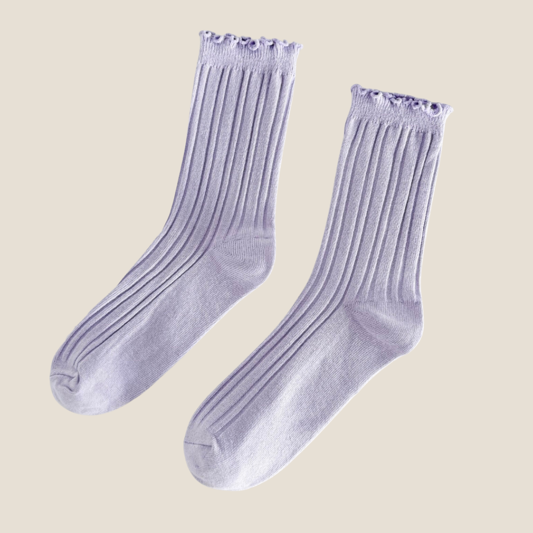 Green ruffle socks shown in the lavender purple colorway, ribbed flat-lay pair with a ruffle cuff.