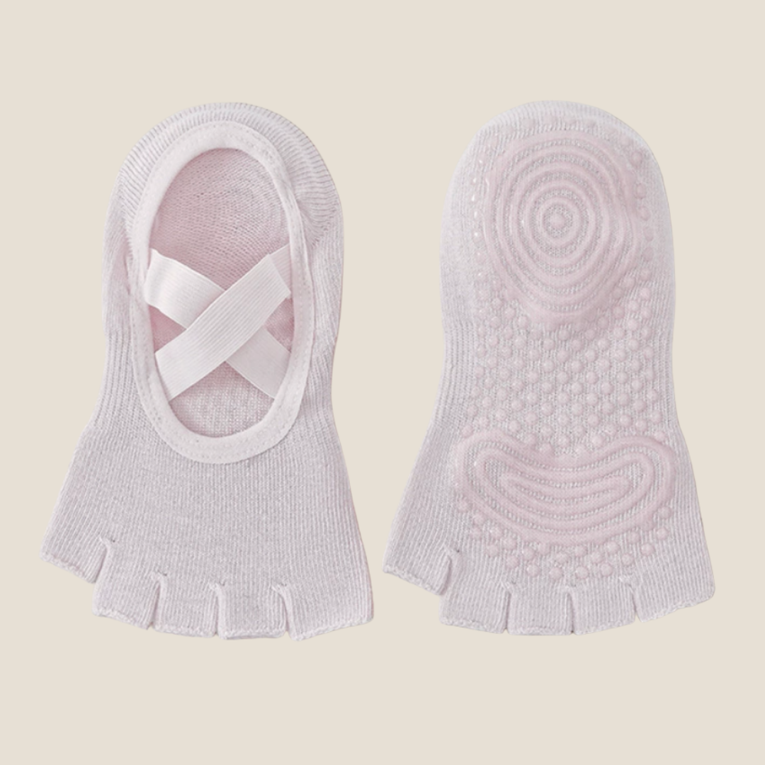 Half toe socks in pale lavender, featuring a cross-strap cuff and swirl grip sole. Displayed as a pair for yoga and pilates.
