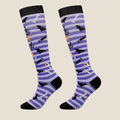 Halloween knee socks in purple with black cats and bats, featuring a spooky pattern. Worn on legs for a costume look.