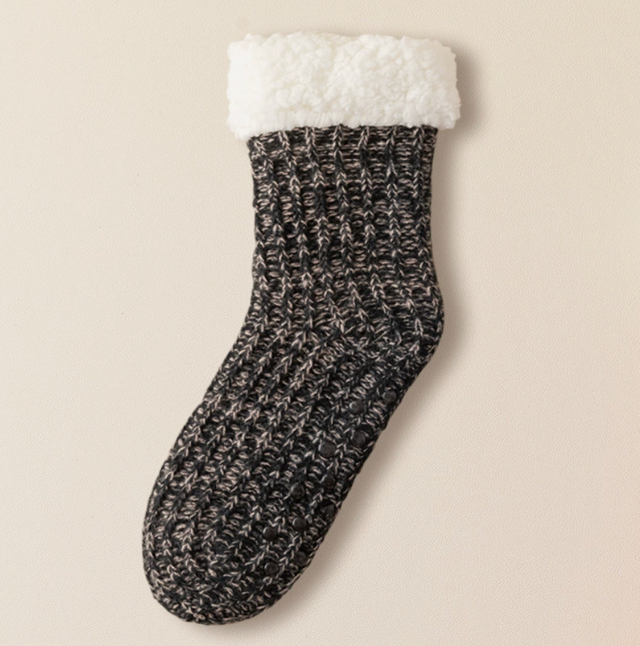 Hospital slipper socks in charcoal marled knit, featuring a plush sherpa cuff and grip sole. Displayed flat on a neutral surface.