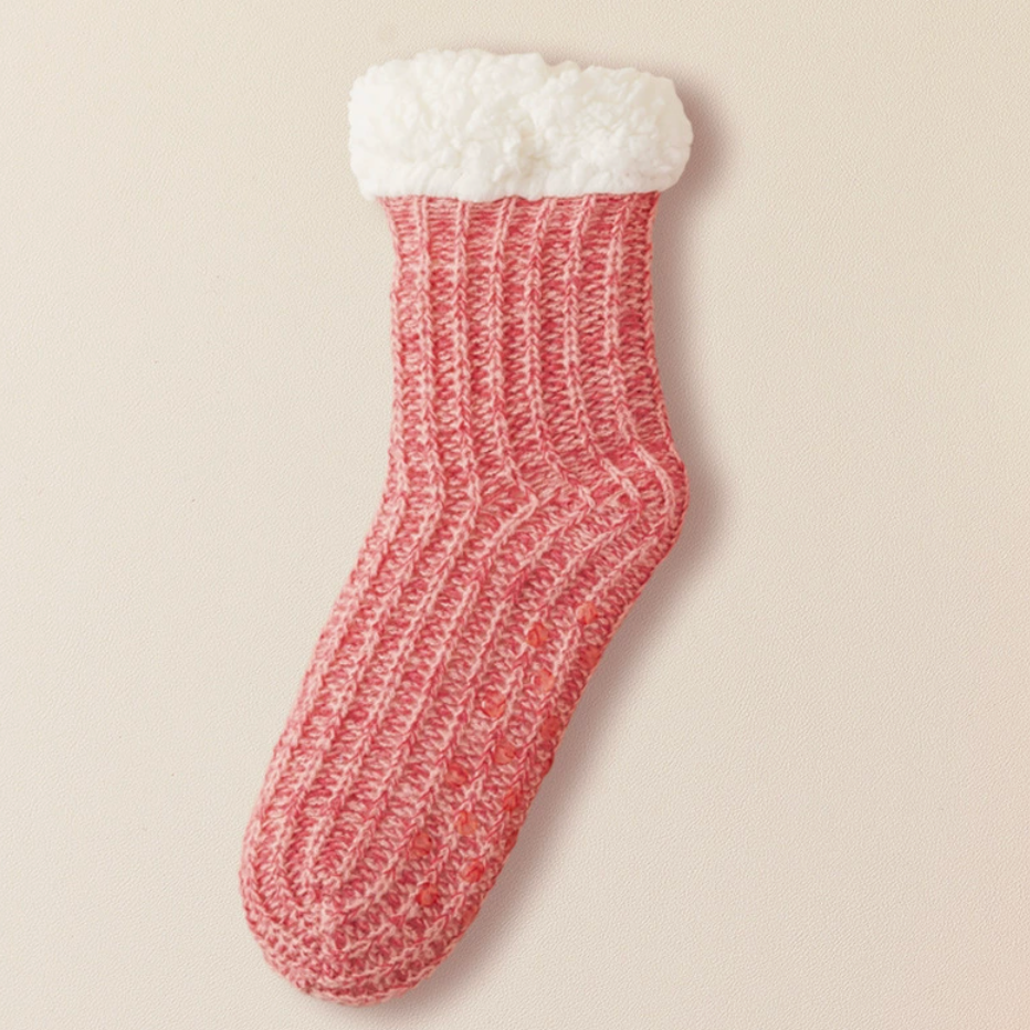 Hospital slipper socks in red marled knit, featuring a fleece-lined cuff and non-slip base. Laid flat to show the cozy pile.