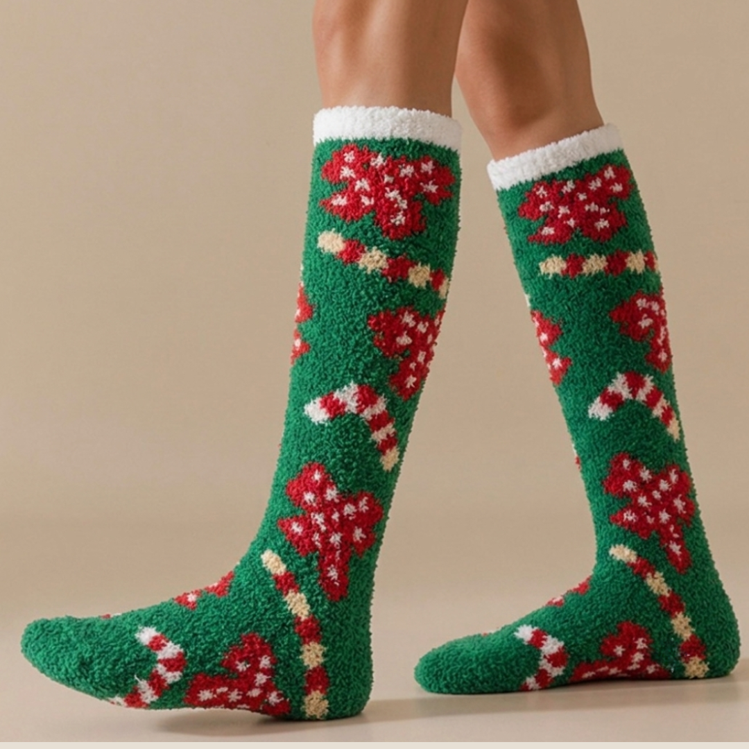 Knee high Christmas socks in green fuzzy fleece with a holiday motif, worn over the calf, side view.