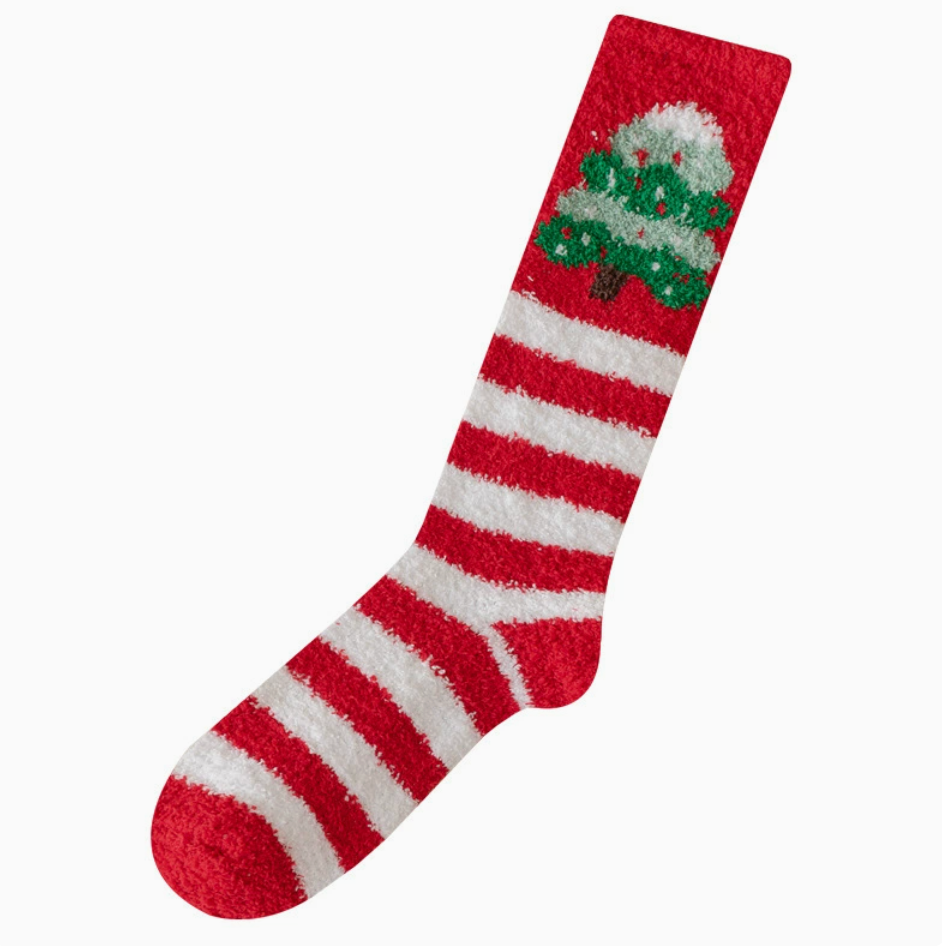 Knee high Christmas socks in red and white stripes with a Christmas-tree pompom detail, on a foot form.