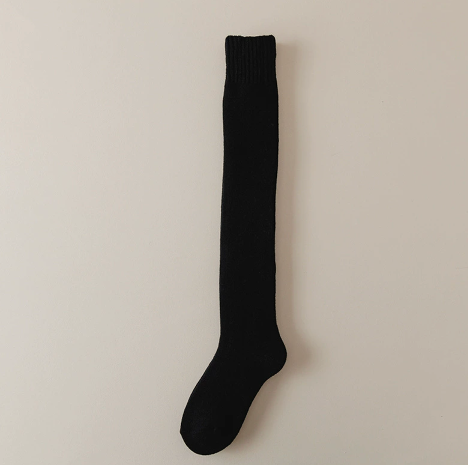 Knee high thermal socks in black, a single over-the-calf sock laid flat.