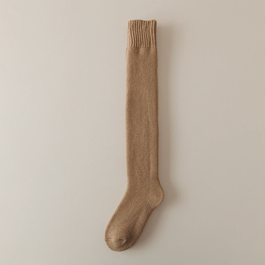 Knee high thermal socks in coffee tan, a single over-the-calf sock shown flat.