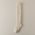 Knee high thermal socks in cream, a single over-the-calf sock shown flat.
