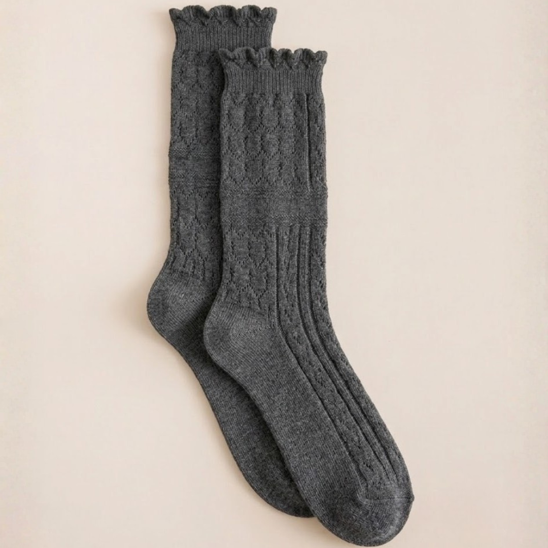Ladies boot socks in charcoal grey, featuring a cable knit with a scalloped frill cuff. Displayed flat as a pair on a neutral backdrop.