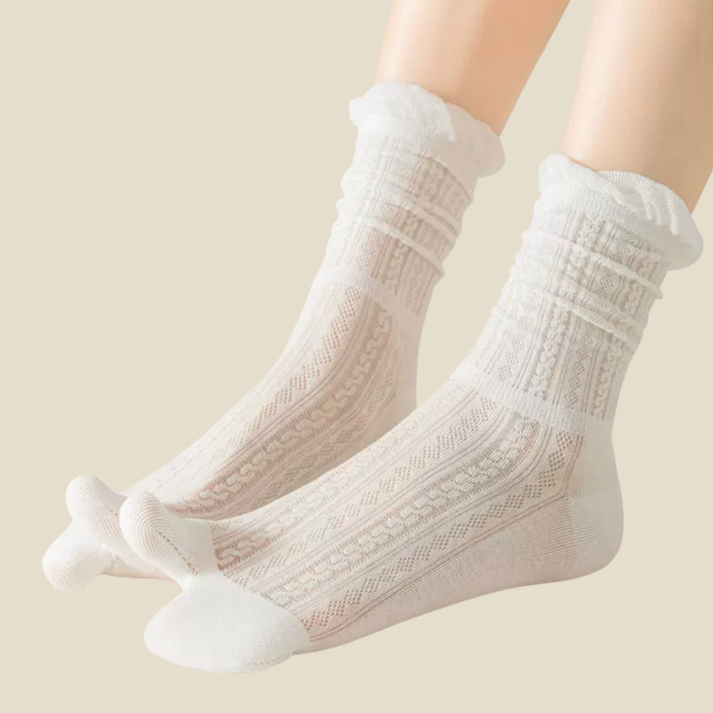 Ladies tabi socks in ivory, featuring a divided-toe design. Shown worn to show the relaxed fit.
