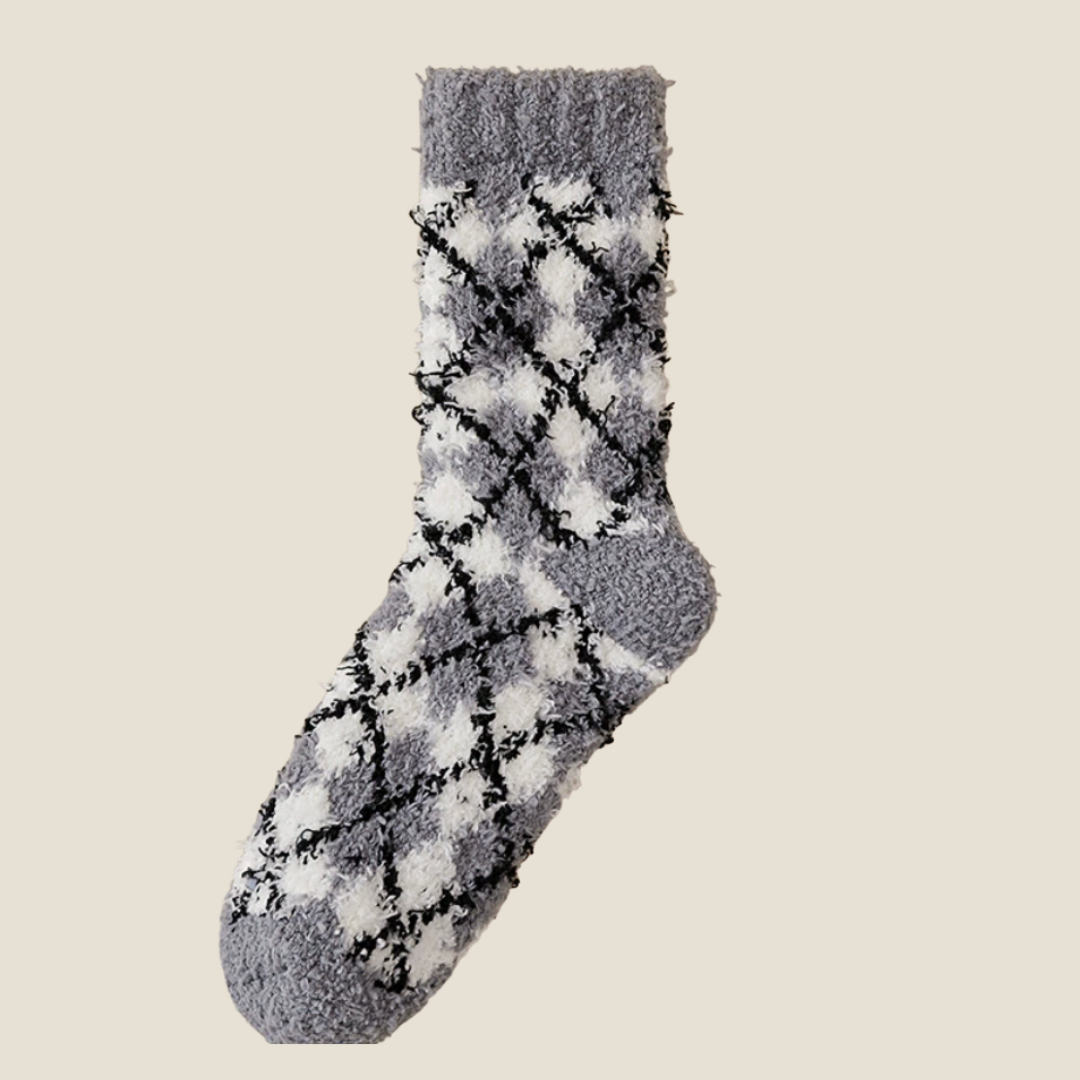 Men's bed socks in charcoal grey fleece, featuring a black diamond argyle design. Displayed flat to highlight the soft plush texture.