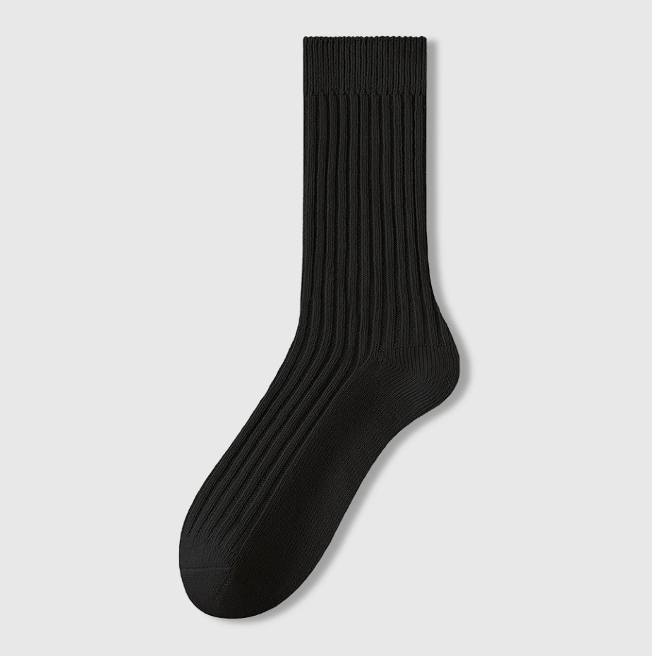 Men's sleep socks in black ribbed cotton, featuring a dense knit body. Shown upright against a light backdrop.