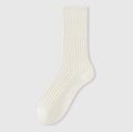 Men's sleep socks in ivory ribbed knit, featuring a lightly cushioned body. Shown standing upright on a neutral surface.