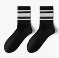 Men's crew socks in black with white varsity stripes, featuring a ribbed cuff. Shown as a flat-lay pair on a neutral backdrop.