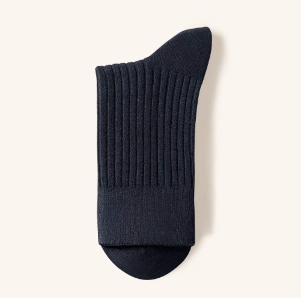 Men's merino wool dress socks in navy blue ribbed wool, featuring a cushioned foot. Shown as a single flat-lay on a light surface.