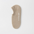 Men's no show socks in beige, featuring a soft low-cut knit. Shown as a single flat-lay on a neutral surface.