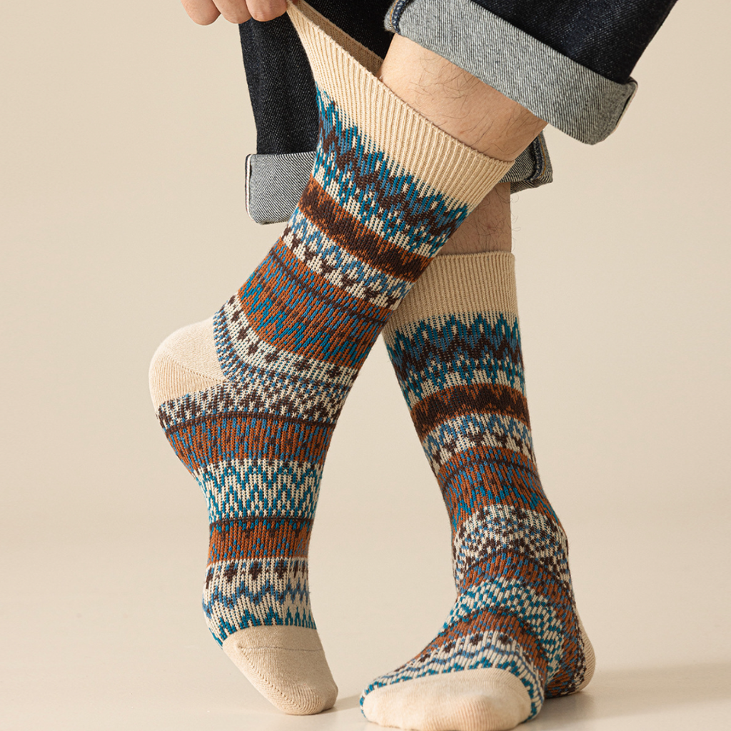 Men's vintage socks in ivory Fair Isle knit, worn on the feet, side view.