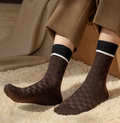 Men's wool dress socks in brown basketweave knit, featuring a white stripe accent. Worn with trousers.